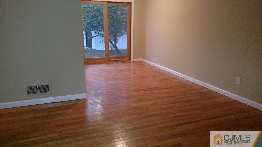 23 Wilshire Road Edison, NJ 08817 - Photo 3 of 21 a view of an empty room with wooden floor and a window