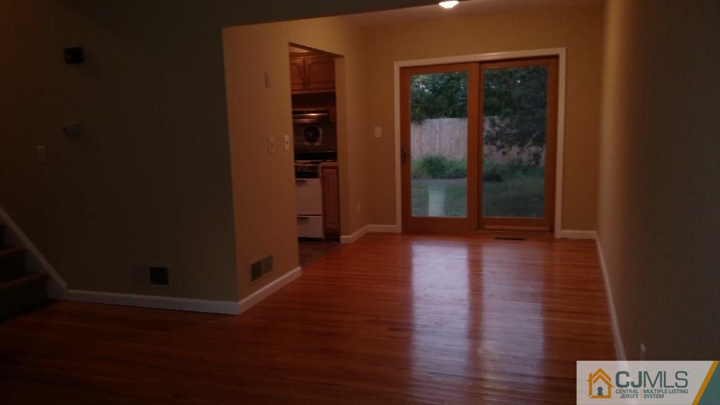 23 Wilshire Road Edison, NJ 08817 - Photo 4 of 21 an empty room with wooden floor and windows