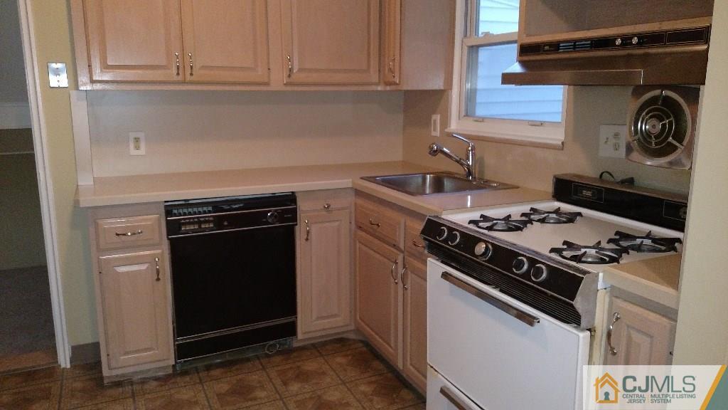 23 Wilshire Road Edison, NJ 08817 - Photo 5 of 21 a white stove top oven sitting inside of a kitchen