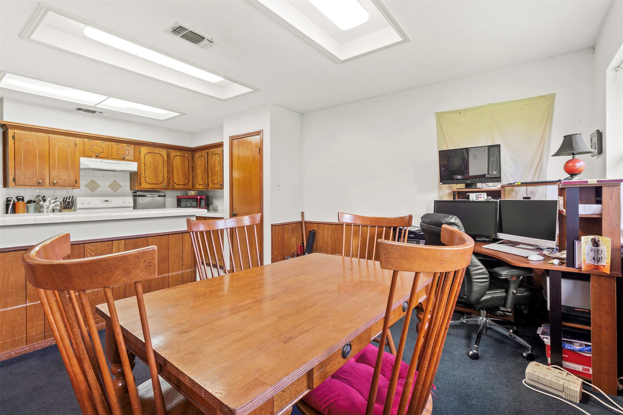 206 Stanford Road Lake Jackson, TX 77566 - Photo 19 of 26 a dining table with chairs and a flat screen tv