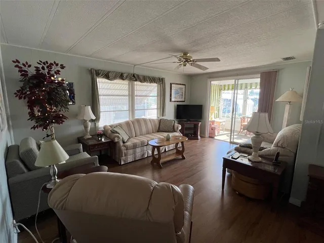 a living room with furniture potted plant and a window