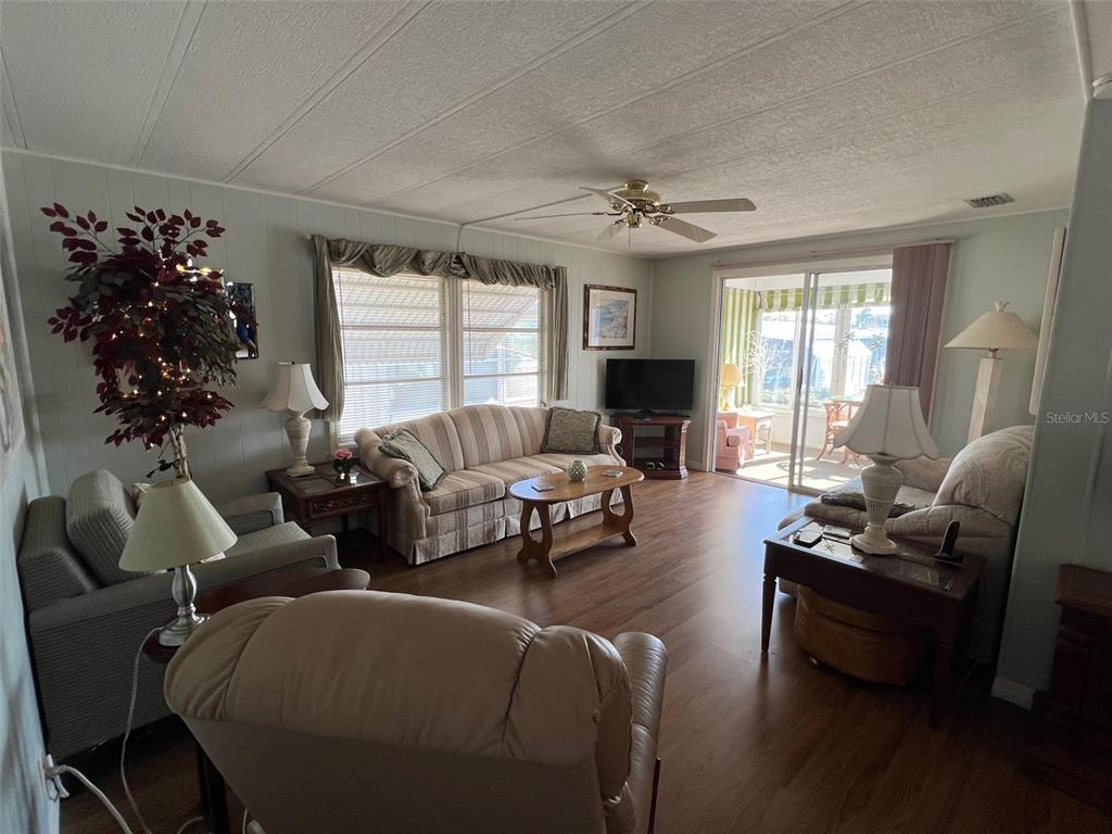 263 Sago Palm Street Largo, FL 33778 - Photo 14 of 29 a living room with furniture potted plant and a window