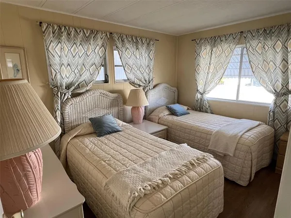 a bedroom with two beds and a window