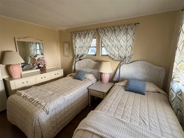 a bedroom with double bed and a large mirror