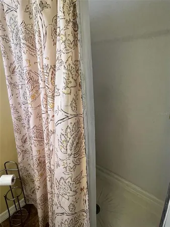 a bathroom with a shower curtain and a window