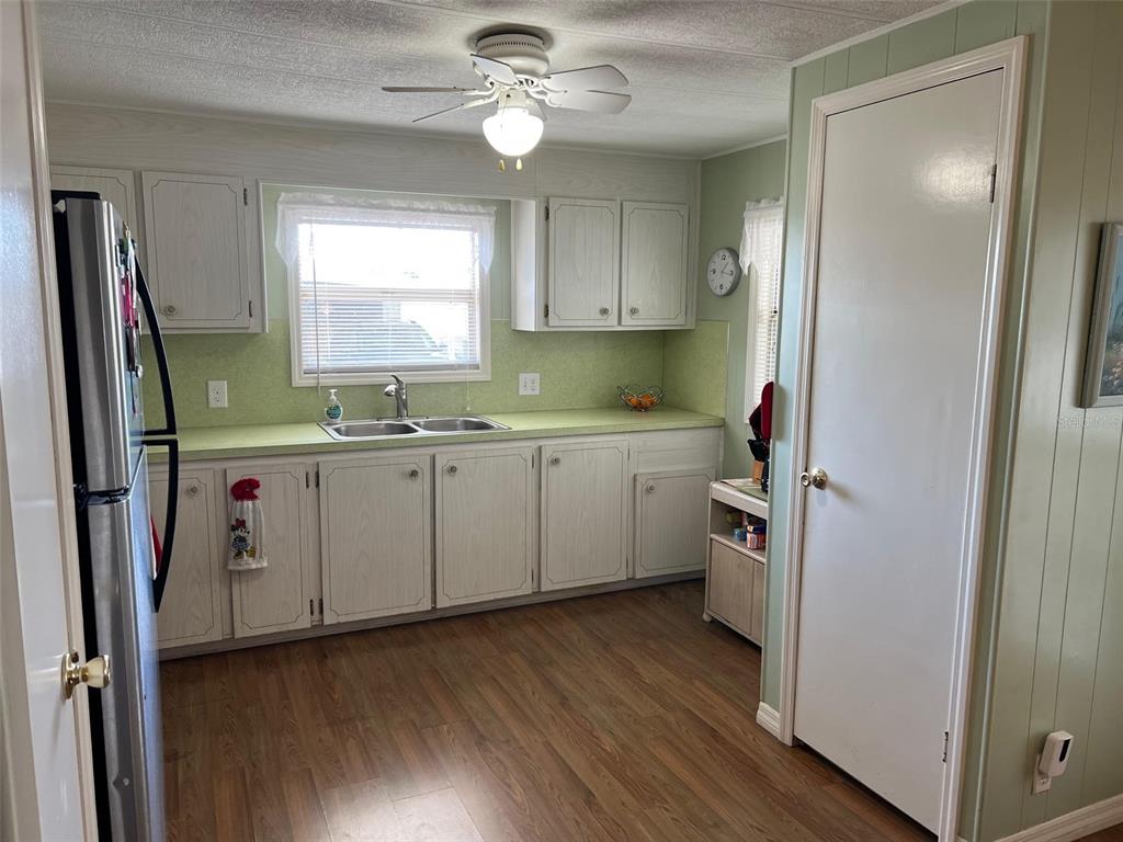 263 Sago Palm Street Largo, FL 33778 - Photo 9 of 29 a kitchen with a sink appliances cabinets and a window