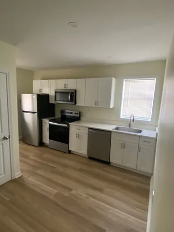 a kitchen with a refrigerator and a stove
