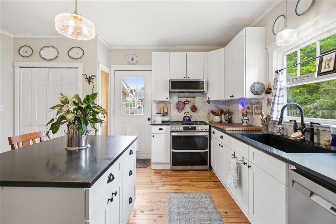 314 South Fairplay Street Seneca, SC 29678 - Photo 13 of 50 This bright kitchen features wood flooring and a kitchen island, perfect for culinary endeavors.