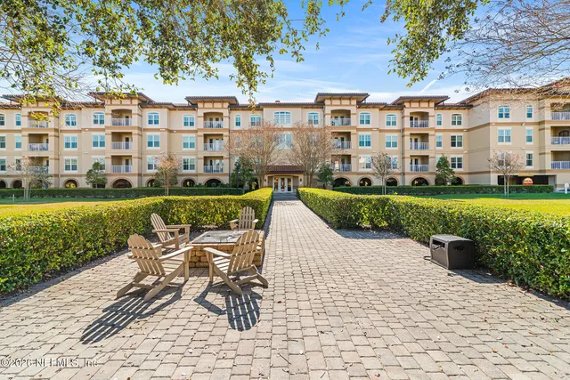 a view of a patio with a table and chairs