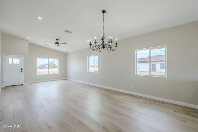 a kitchen with kitchen island a counter top space a sink a window and stainless steel appliances