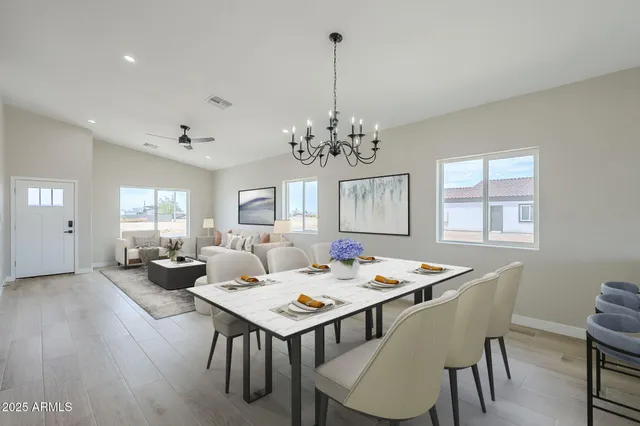 a living room with lots of furniture and view of kitchen