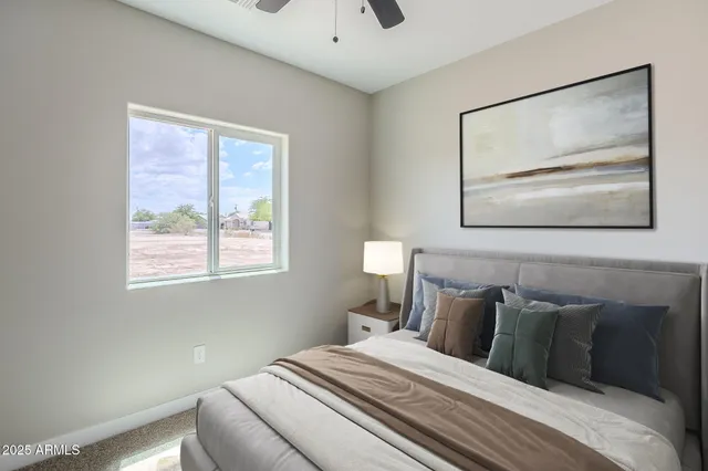 a bedroom with a large bed and a potted plant