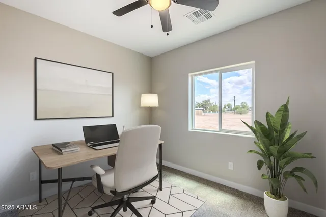 a bedroom with a bed and a painting on the wall