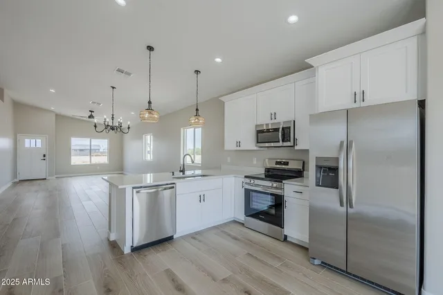 a kitchen with stainless steel appliances a refrigerator sink and microwave
