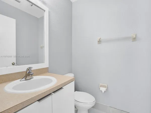 a bathroom with a sink a toilet and mirror