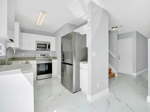 a kitchen with a refrigerator sink and stove