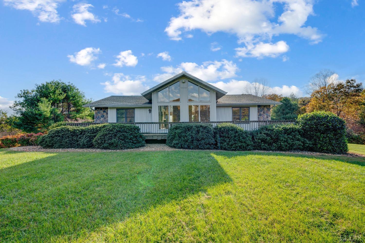 7903 Charlemont Road Goode, VA 24556 - Photo 1 of 47 a front view of a house with yard and green space