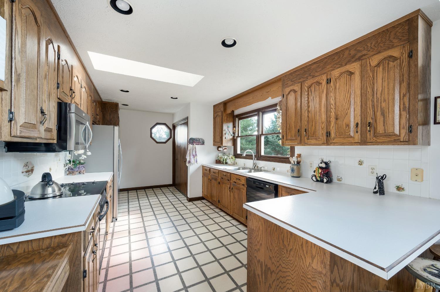 7903 Charlemont Road Goode, VA 24556 - Photo 11 of 47 a kitchen that has a sink and a stove in it