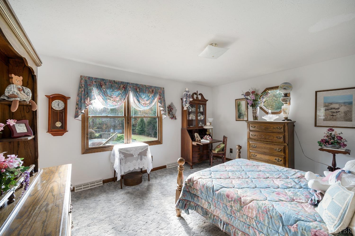 7903 Charlemont Road Goode, VA 24556 - Photo 24 of 47 a bedroom with a bed and large windows