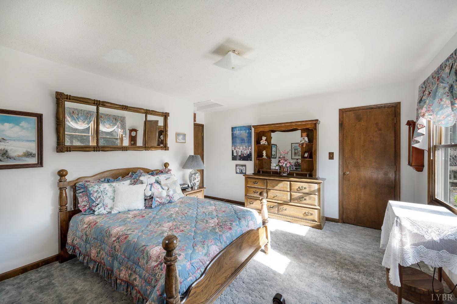 7903 Charlemont Road Goode, VA 24556 - Photo 25 of 47 a bedroom with a bed and glass walk in closet