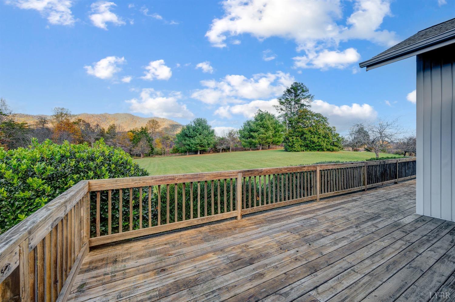 7903 Charlemont Road Goode, VA 24556 - Photo 32 of 47 a balcony with wooden floor and fence