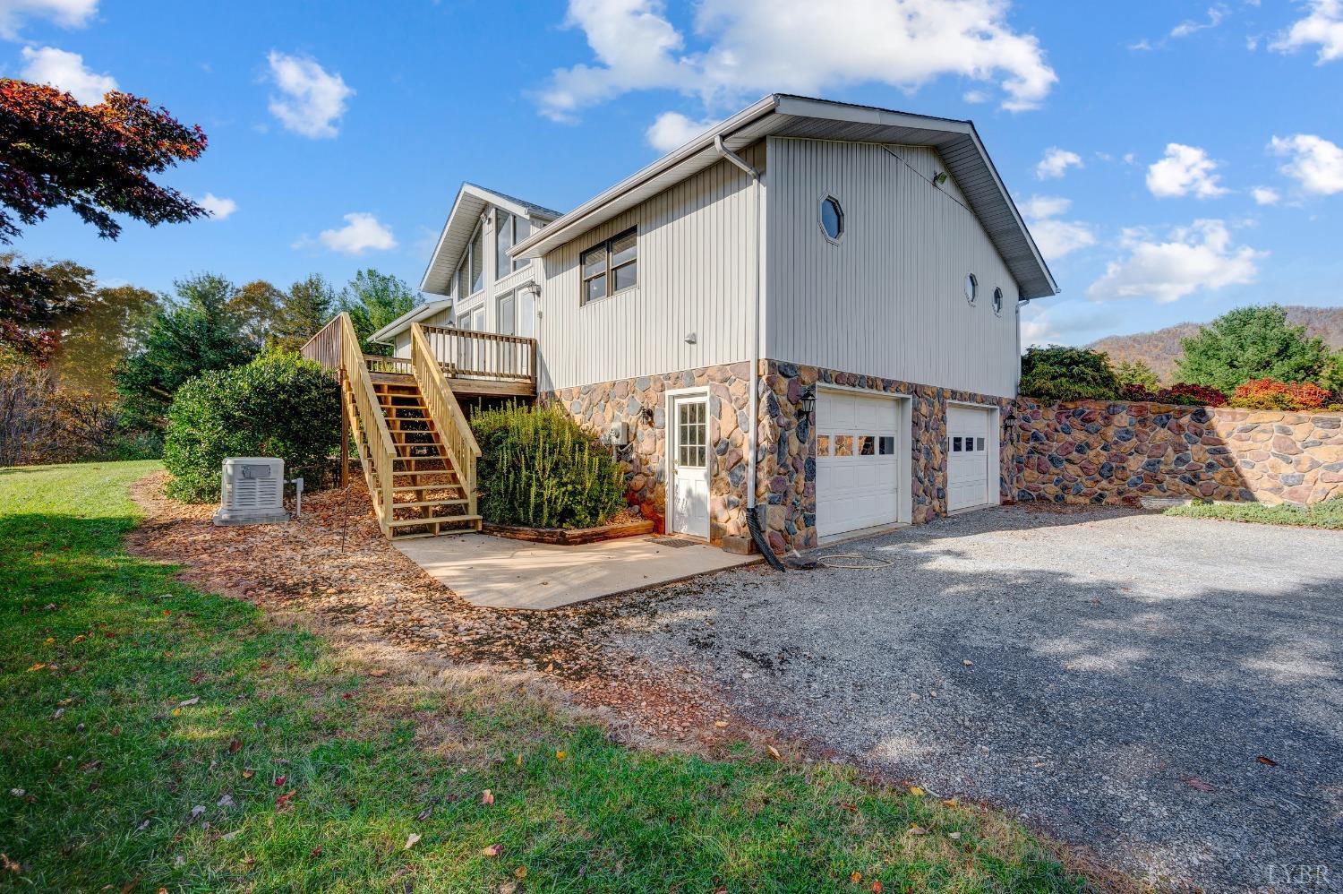 7903 Charlemont Road Goode, VA 24556 - Photo 35 of 47 a front view of a house with a yard and garage