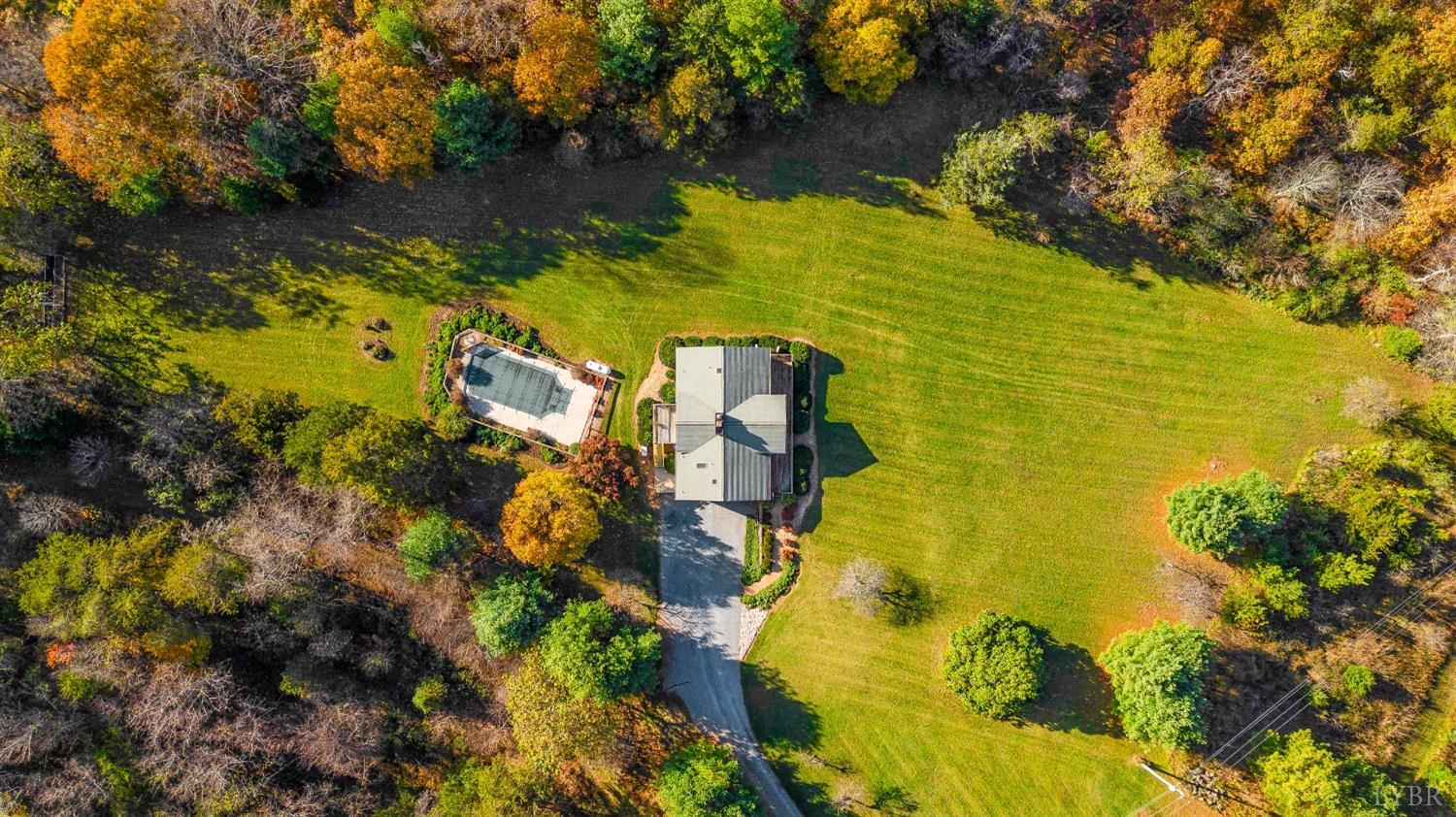 7903 Charlemont Road Goode, VA 24556 - Photo 43 of 47 a view of a lake with a building in the background