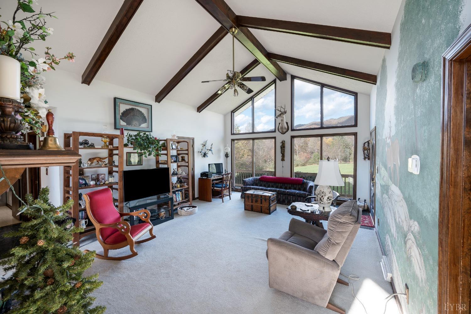 7903 Charlemont Road Goode, VA 24556 - Photo 5 of 47 a living room with furniture gym equipment and a fireplace