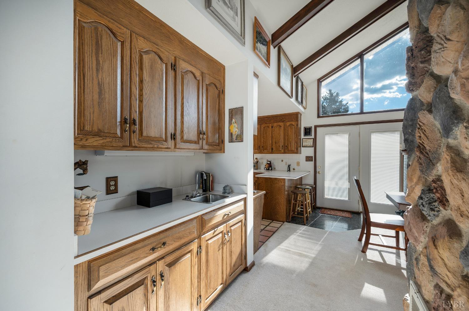 7903 Charlemont Road Goode, VA 24556 - Photo 8 of 47 a kitchen with stainless steel appliances granite countertop a stove a sink and a refrigerator with wooden floors