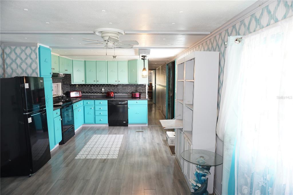 15371 Mango Drive Punta Gorda, FL 33955 - Photo 12 of 62 a kitchen with stainless steel appliances a refrigerator and a wooden floor