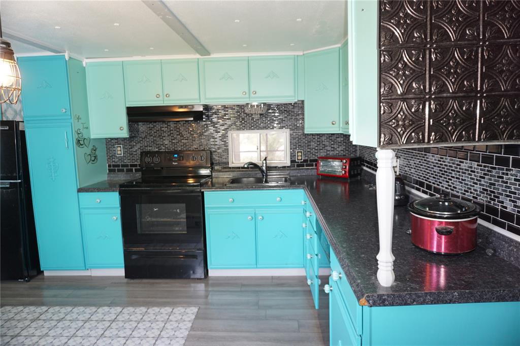 15371 Mango Drive Punta Gorda, FL 33955 - Photo 15 of 62 a kitchen with stainless steel appliances granite countertop a stove a sink and a microwave