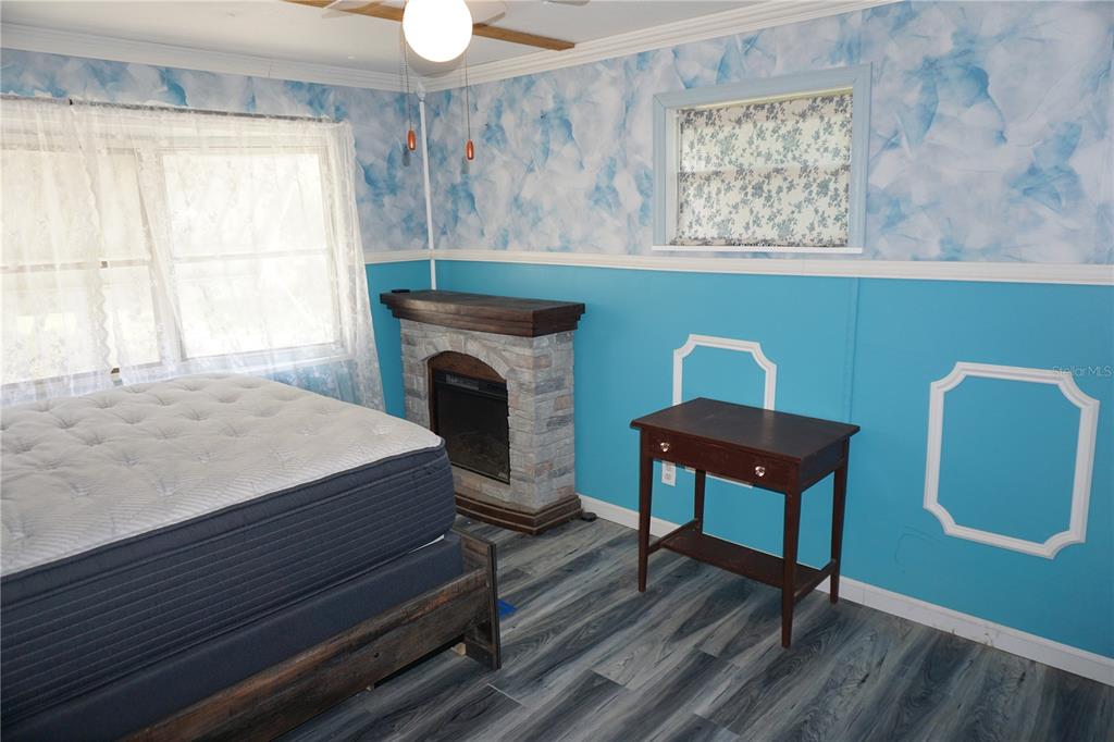 15371 Mango Drive Punta Gorda, FL 33955 - Photo 20 of 62 a bedroom with a chair and a fireplace