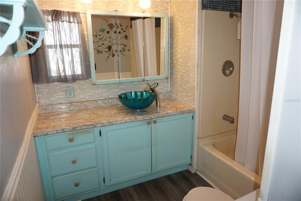 15371 Mango Drive Punta Gorda, FL 33955 - Photo 22 of 62 a bathroom with a granite countertop sink a toilet and bathtub