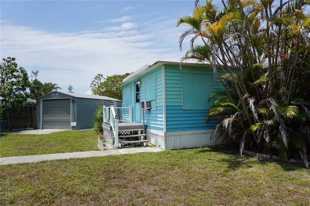 15371 Mango Drive Punta Gorda, FL 33955 - Photo 33 of 62 a backyard of a house with table and sofas