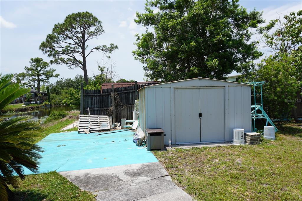 15371 Mango Drive Punta Gorda, FL 33955 - Photo 40 of 62 a view of backyard with wooden fence and a bench