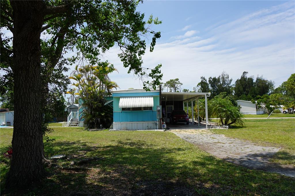 15371 Mango Drive Punta Gorda, FL 33955 - Photo 5 of 62 a view of a house with yard and a tree