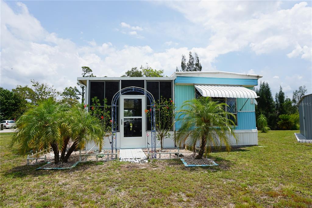 15371 Mango Drive Punta Gorda, FL 33955 - Photo 60 of 62 a front view of a house with garden