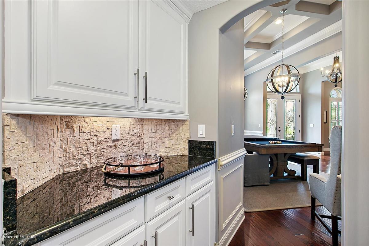 504 Saddlestone Drive St. Johns, FL 32259 - Photo 13 of 42 a kitchen with stainless steel appliances granite countertop wooden cabinets a stove and a sink