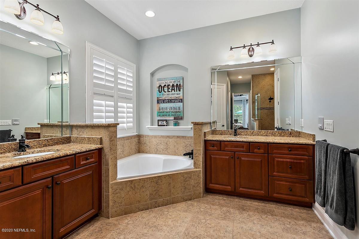 504 Saddlestone Drive St. Johns, FL 32259 - Photo 20 of 42 a spacious bathroom with a granite countertop tub sink and mirror