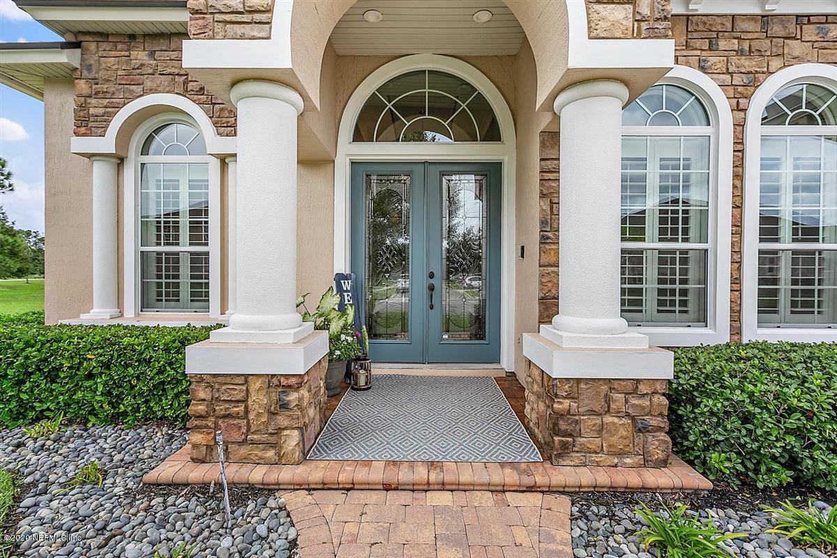 504 Saddlestone Drive St. Johns, FL 32259 - Photo 2 of 42 a view of a brick house with large windows