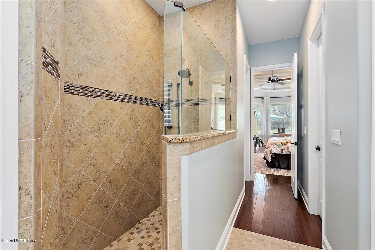 504 Saddlestone Drive St. Johns, FL 32259 - Photo 21 of 42 a view of a walk in closet and bathroom