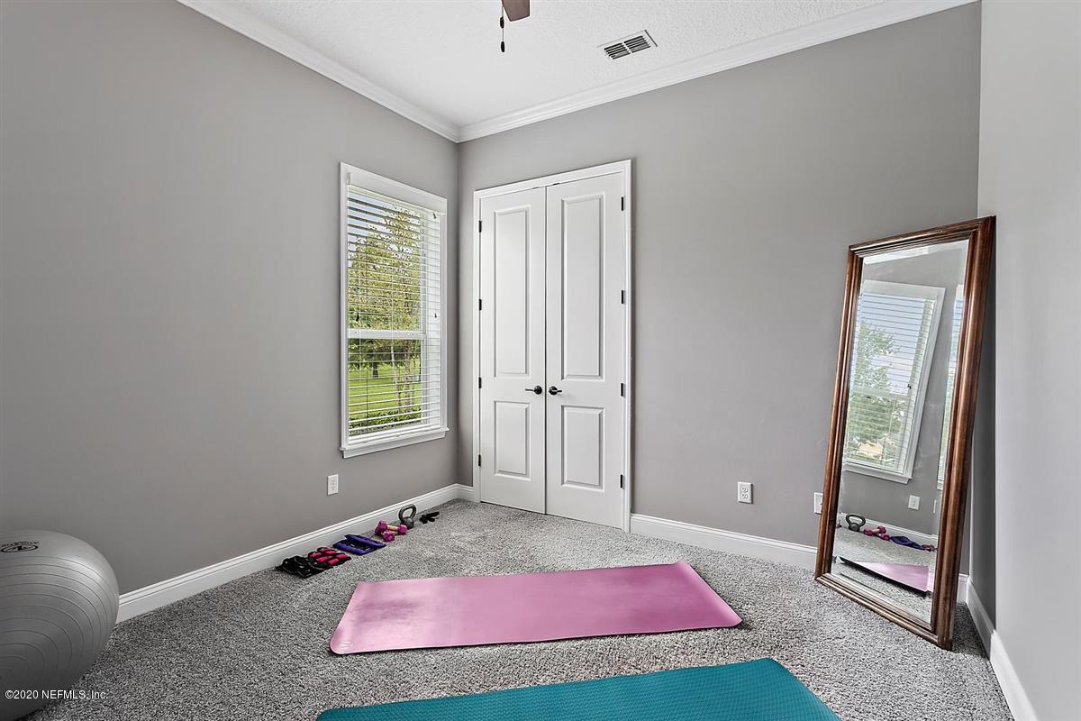 504 Saddlestone Drive St. Johns, FL 32259 - Photo 22 of 42 a bedroom with a bed and a window