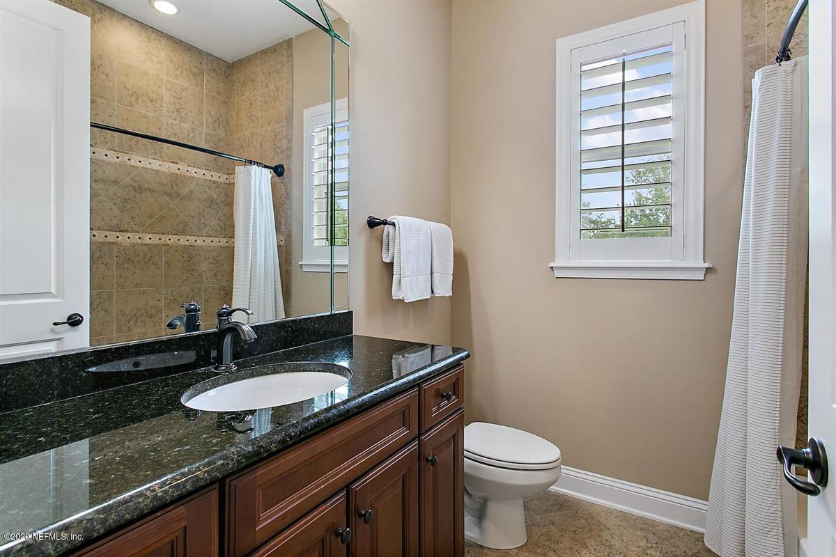 504 Saddlestone Drive St. Johns, FL 32259 - Photo 24 of 42 a bathroom with a granite countertop sink toilet and mirror