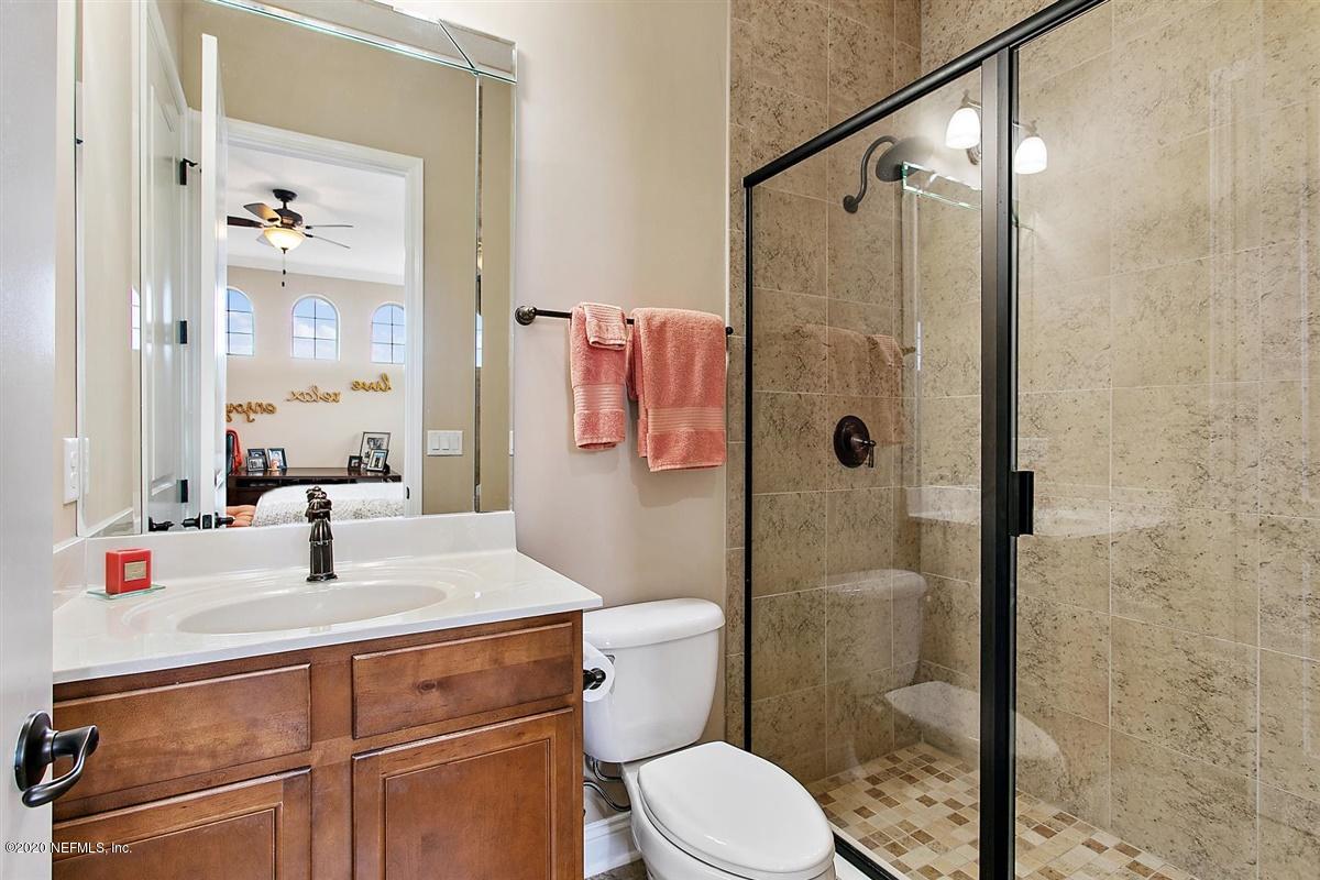 504 Saddlestone Drive St. Johns, FL 32259 - Photo 27 of 42 a bathroom with a sink a toilet and shower