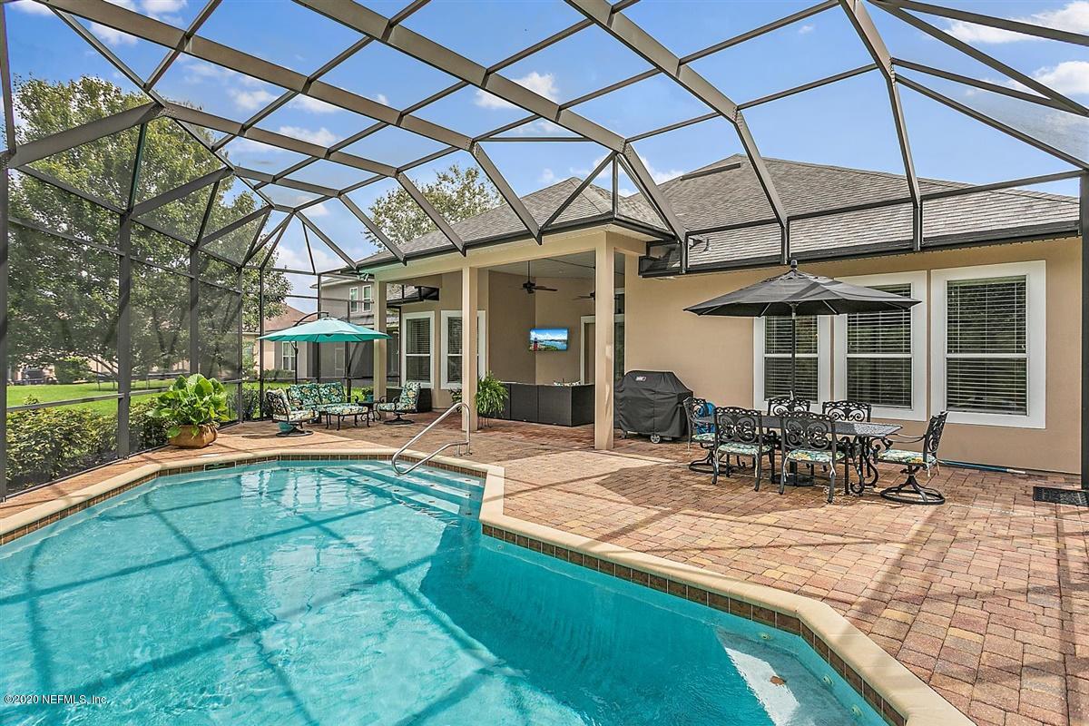 504 Saddlestone Drive St. Johns, FL 32259 - Photo 31 of 42 a view of a patio with a table and chairs and potted plants