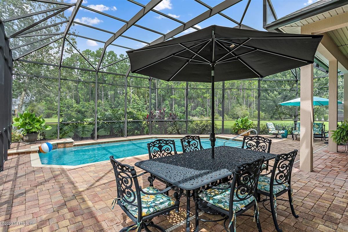 504 Saddlestone Drive St. Johns, FL 32259 - Photo 33 of 42 a table and chairs in the patio