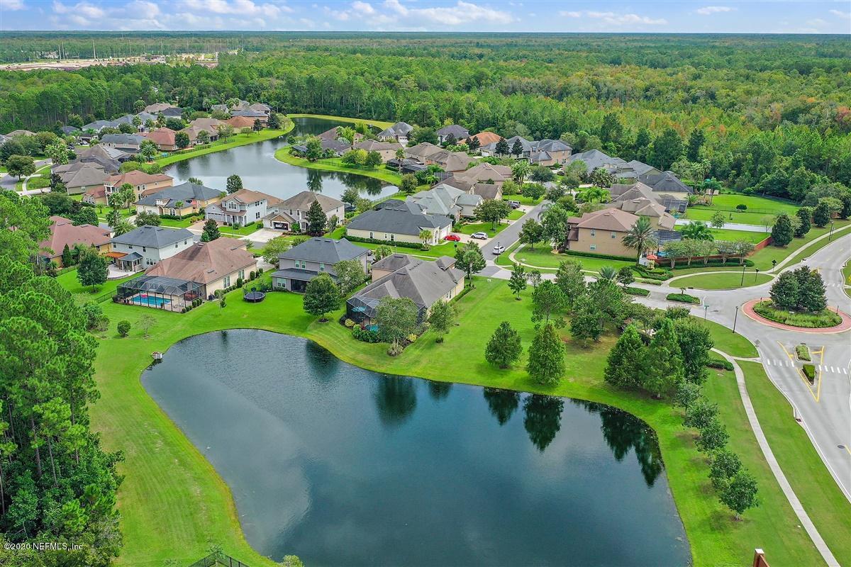 504 Saddlestone Drive St. Johns, FL 32259 - Photo 35 of 42 a view of a lake with a yard