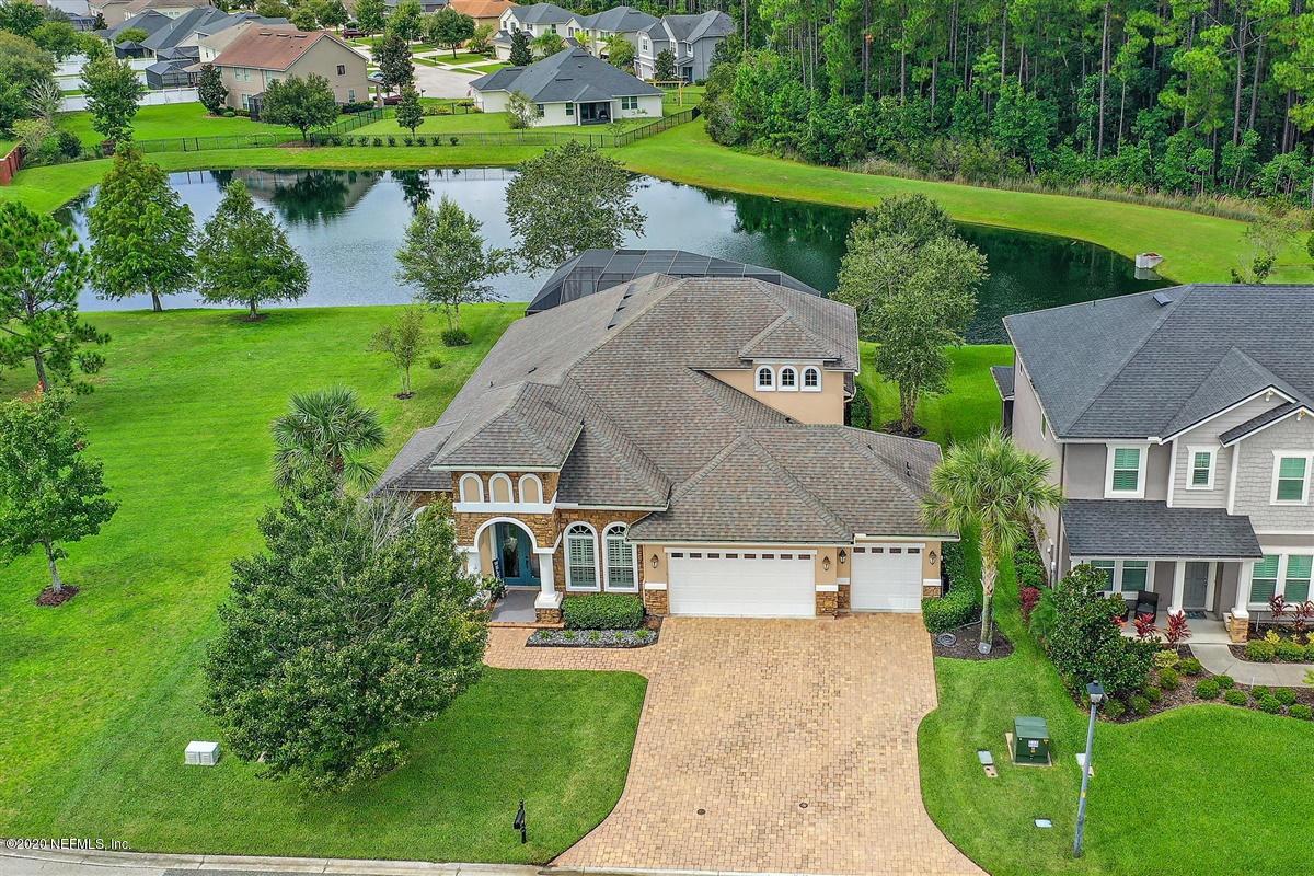 504 Saddlestone Drive St. Johns, FL 32259 - Photo 41 of 42 an aerial view of a house with a yard and lake view