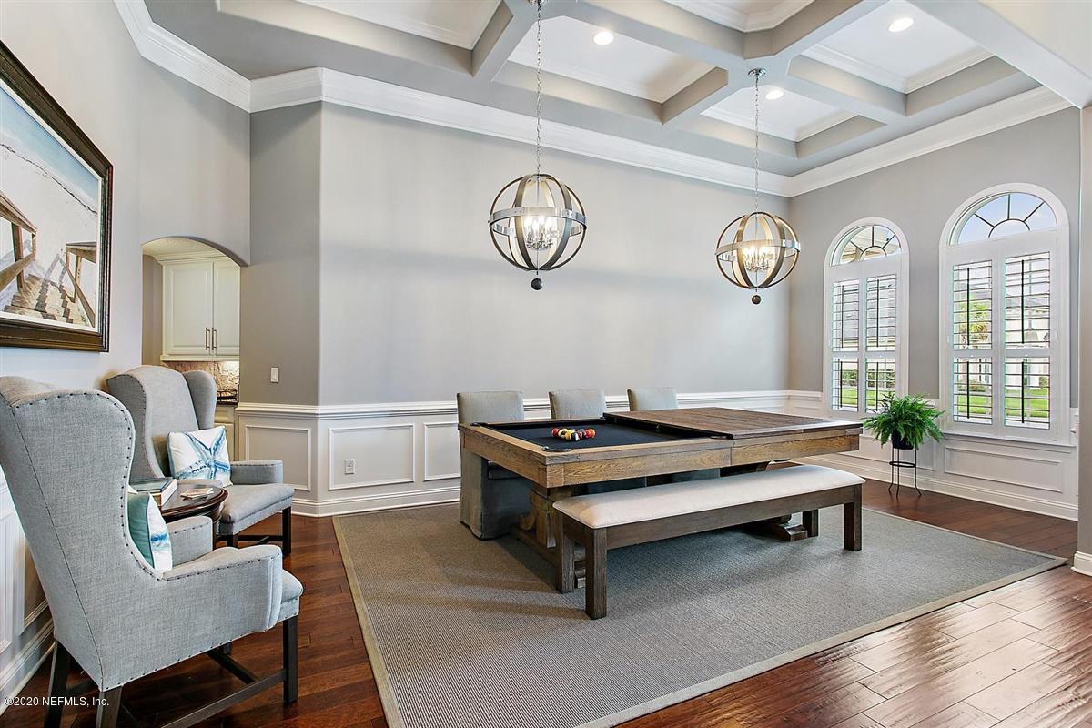 504 Saddlestone Drive St. Johns, FL 32259 - Photo 6 of 42 a living room with furniture a clock on wall and a window