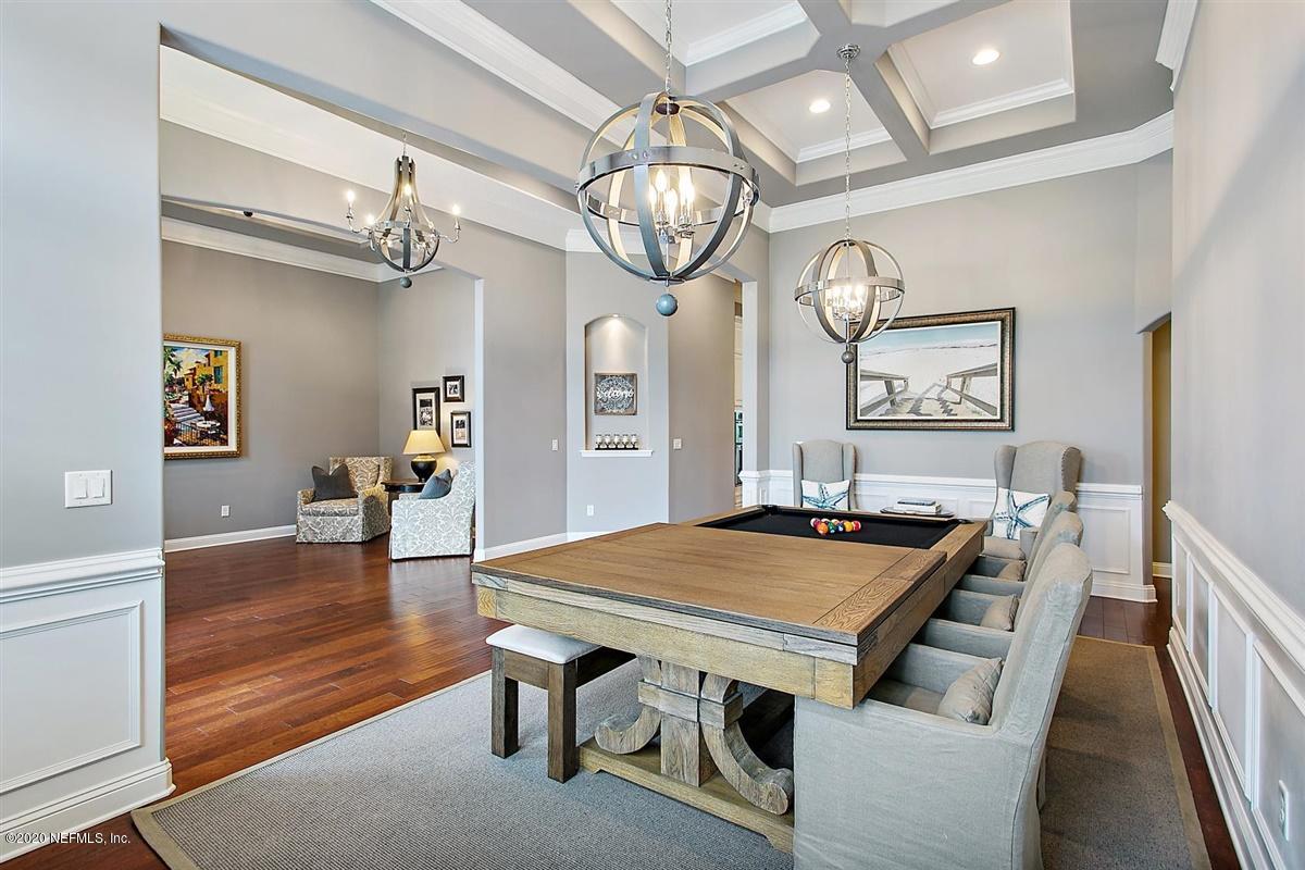504 Saddlestone Drive St. Johns, FL 32259 - Photo 7 of 42 a view of a dining room with furniture a chandelier and wooden floor